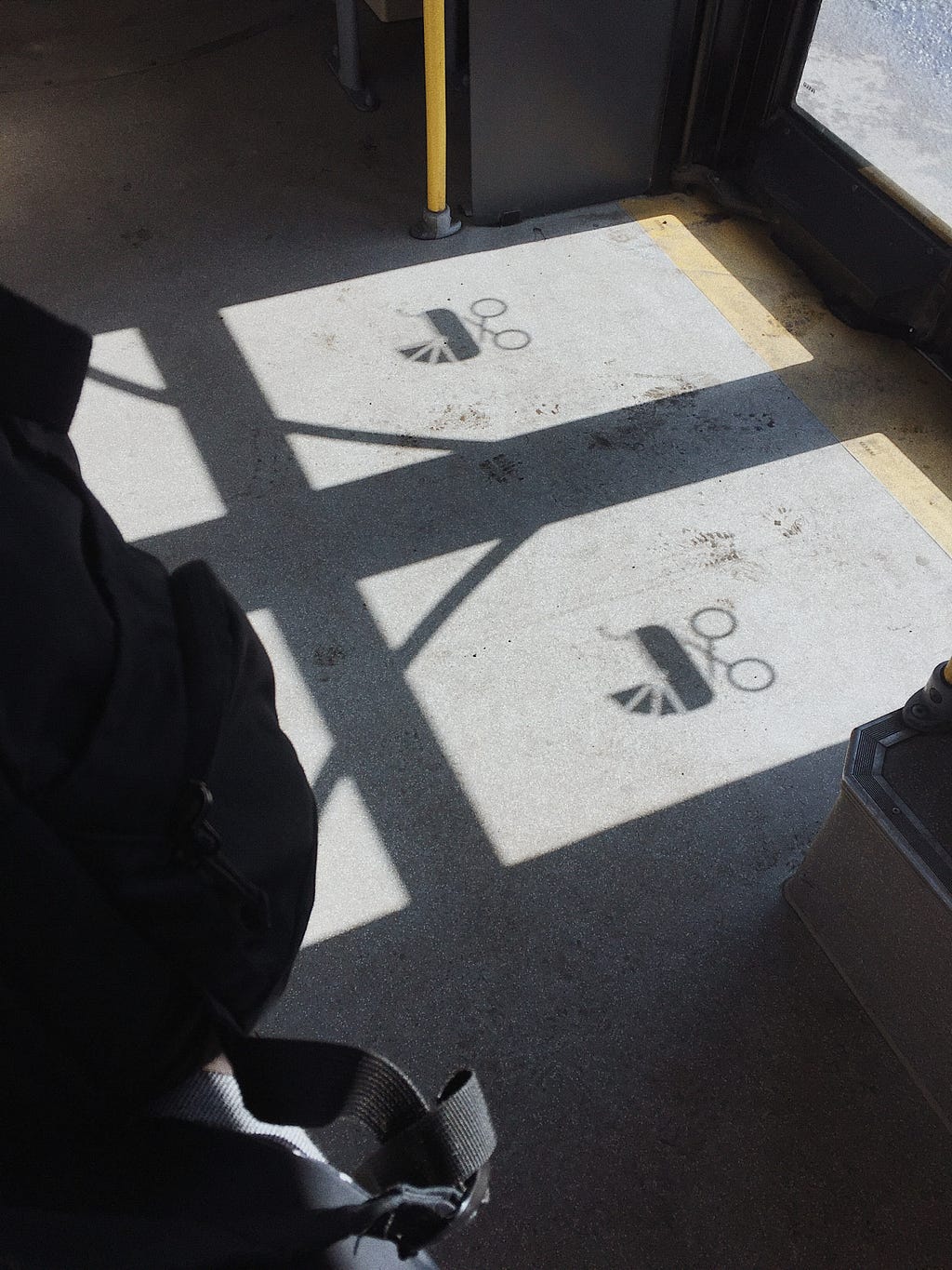 Shadow of pushchair sign on bus floor