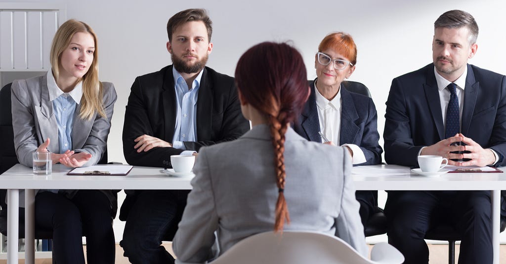 A group of recruiters in the process of interviewing an applicant.