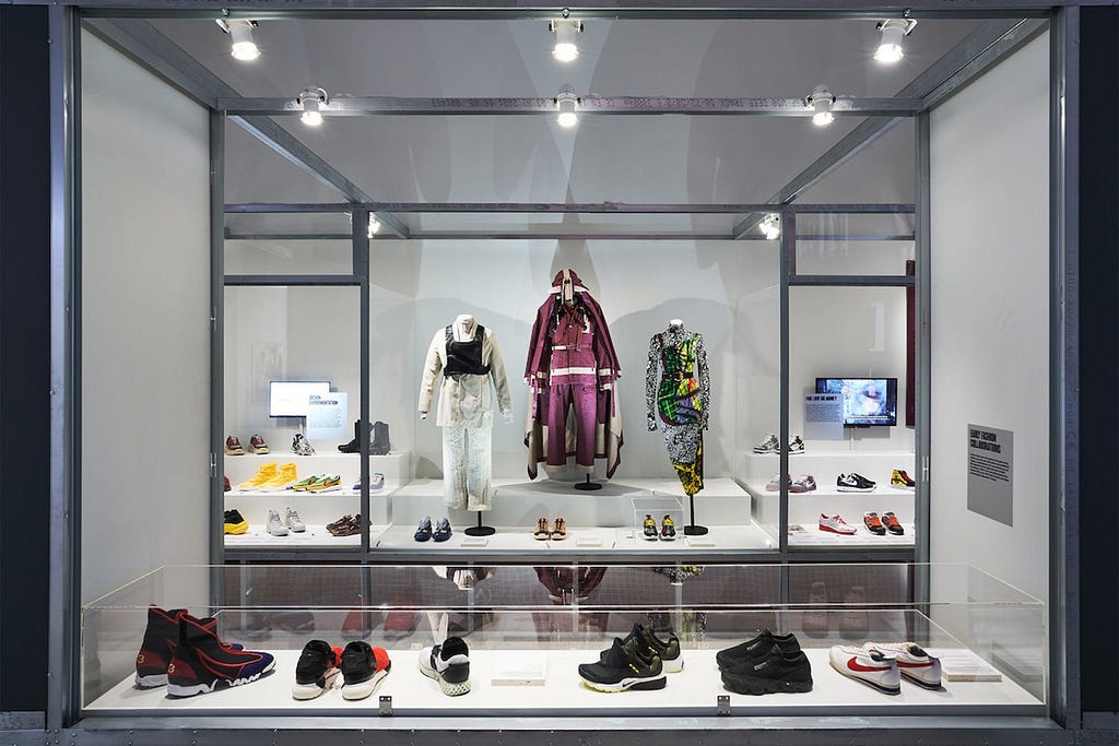 A cabinet filled with expensive sneakers and designer fashion pieces.