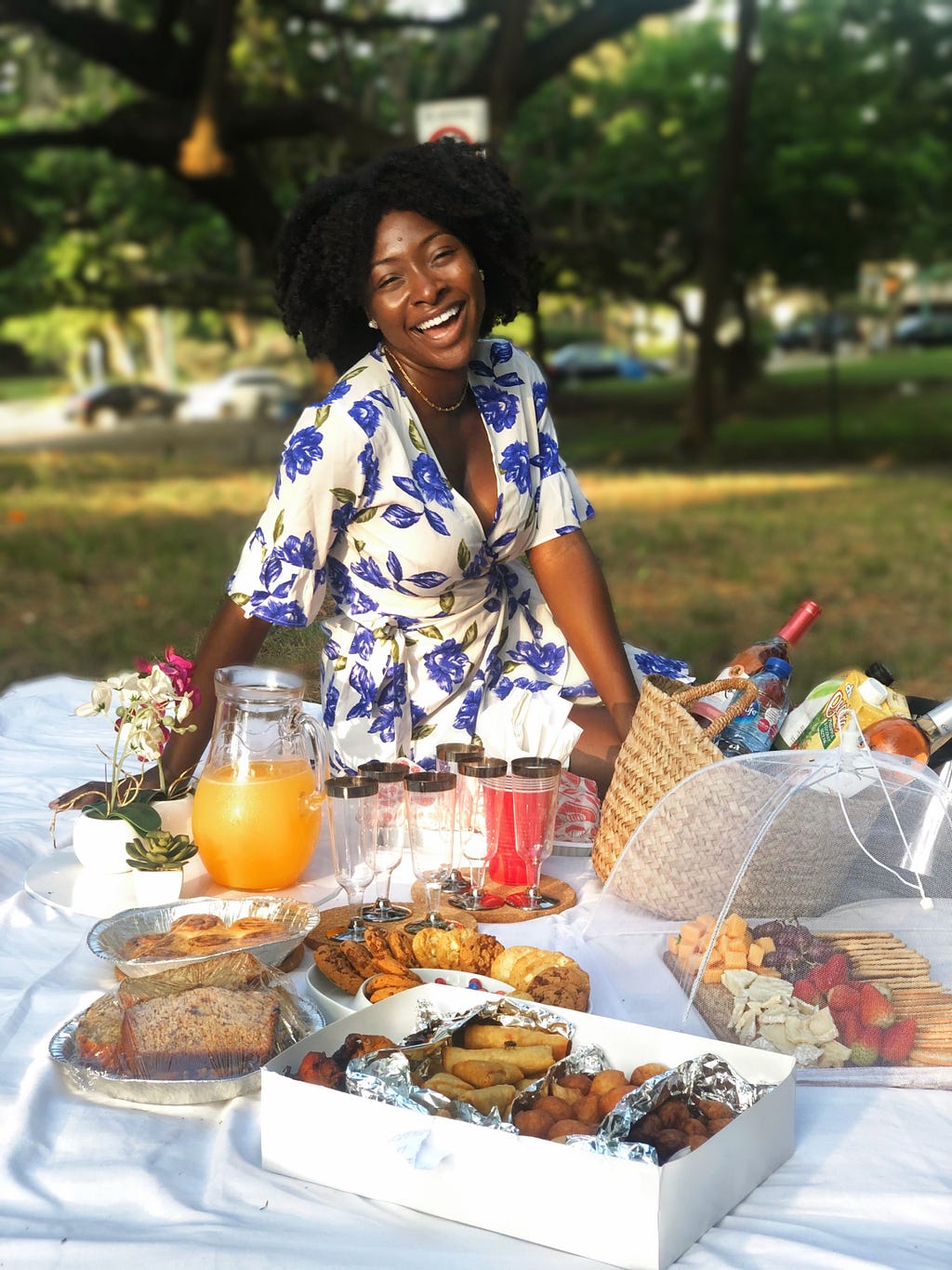 Black girl (author) smiling in front of picnic setup