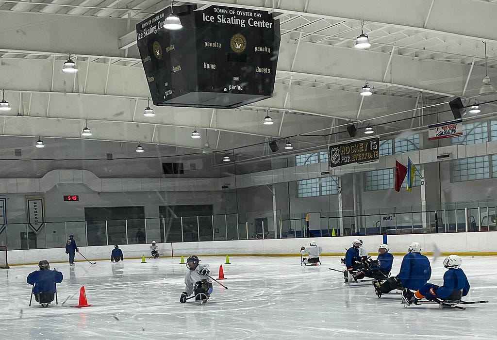 A photo of LI Sled Hockey team members, “The Rough Riders” on the ice