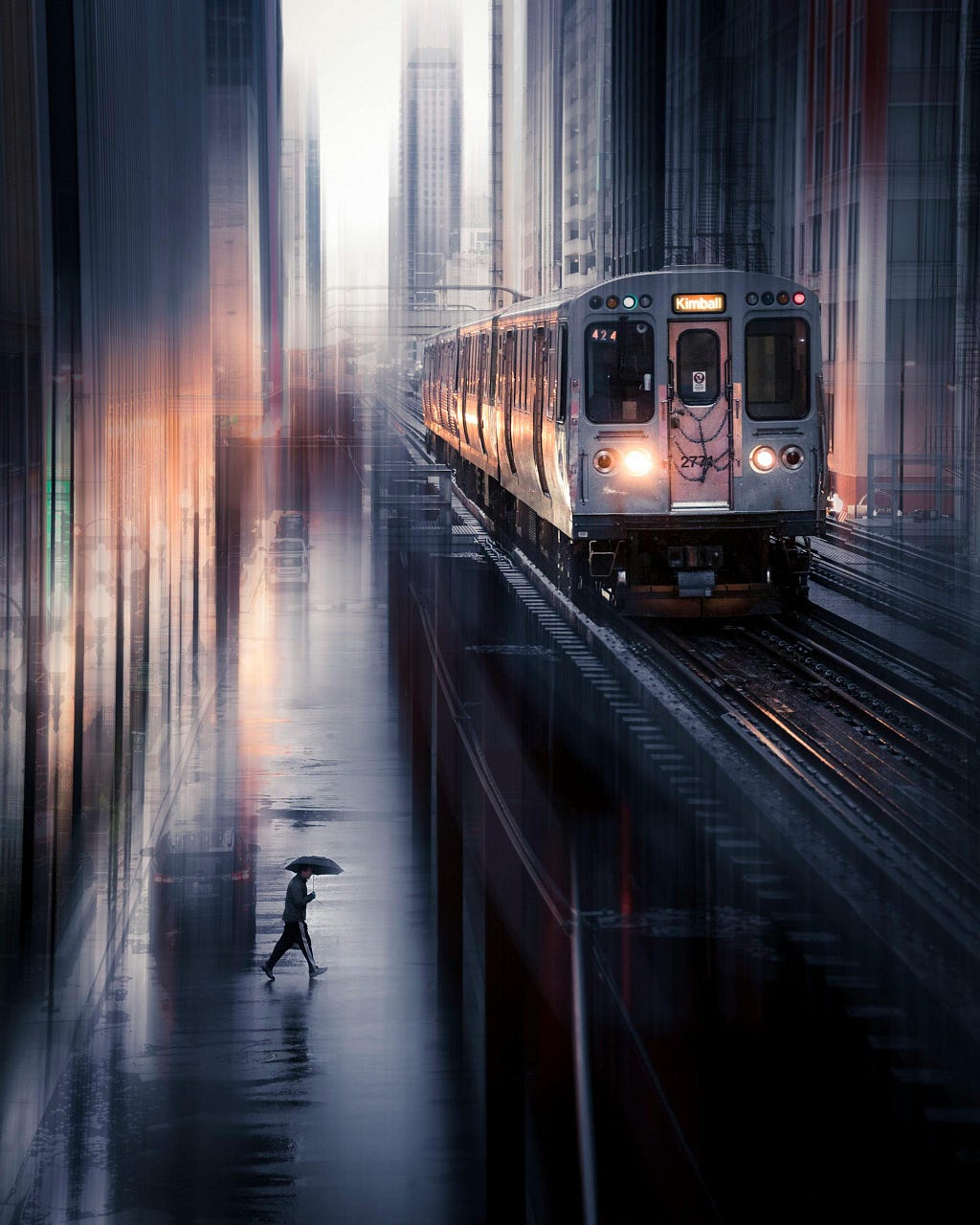 A man with an umbrella walking towards the metro train