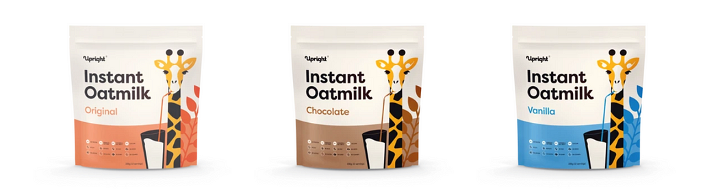 Upright Instant Oatmilk packaging in three flavors, from left to right: original, chocolate, and vanilla.