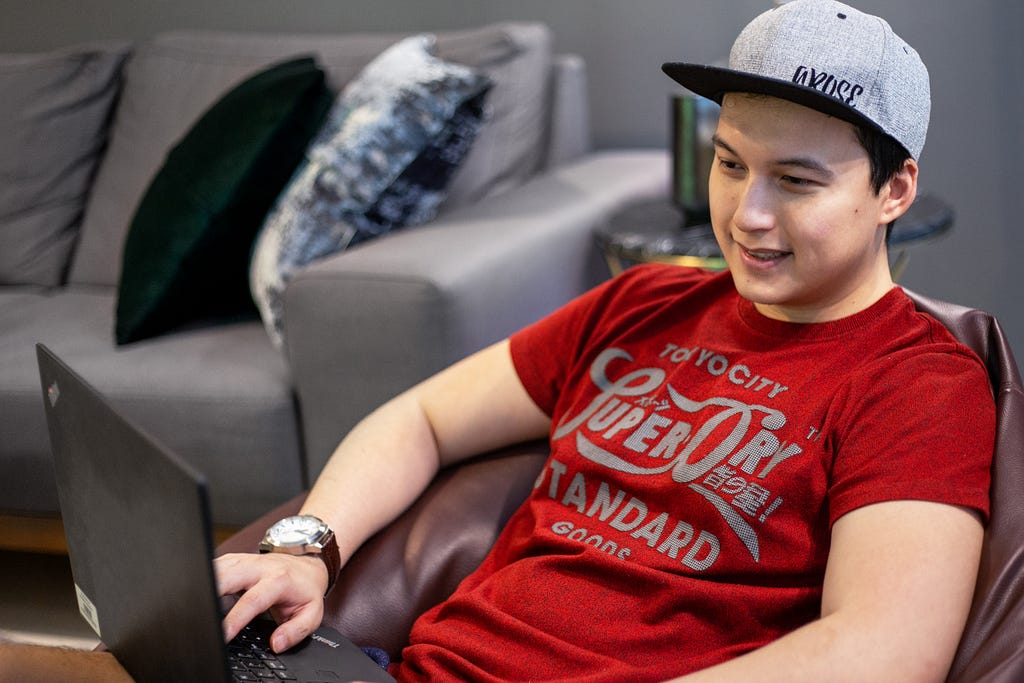 Dubai expat Aaron Chen working on his laptop at home