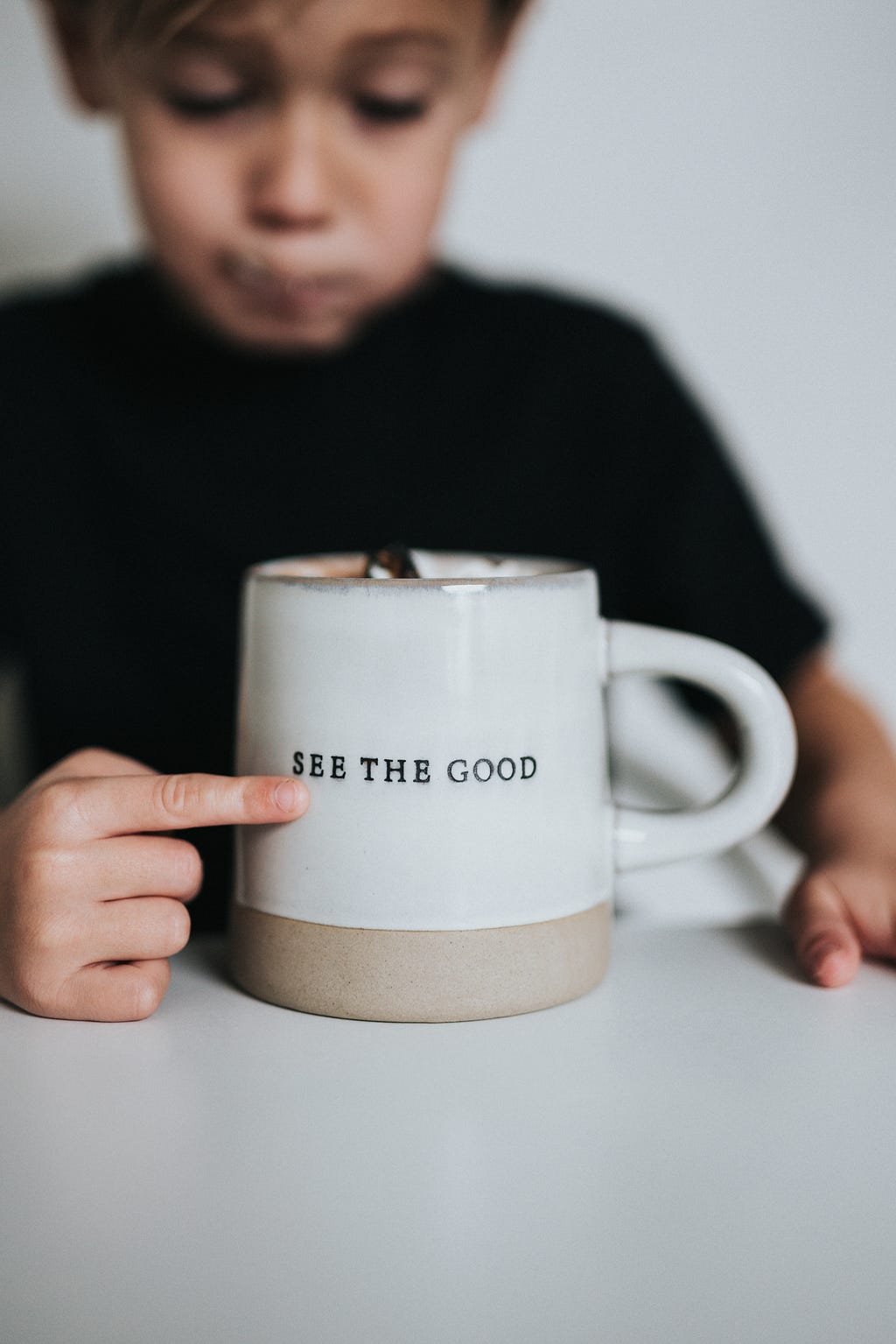 Image of young boy with cup, written on “see the good”