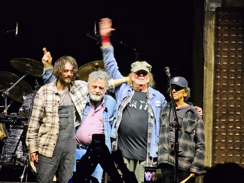 Neil Young and Crazy Horse saluting audience