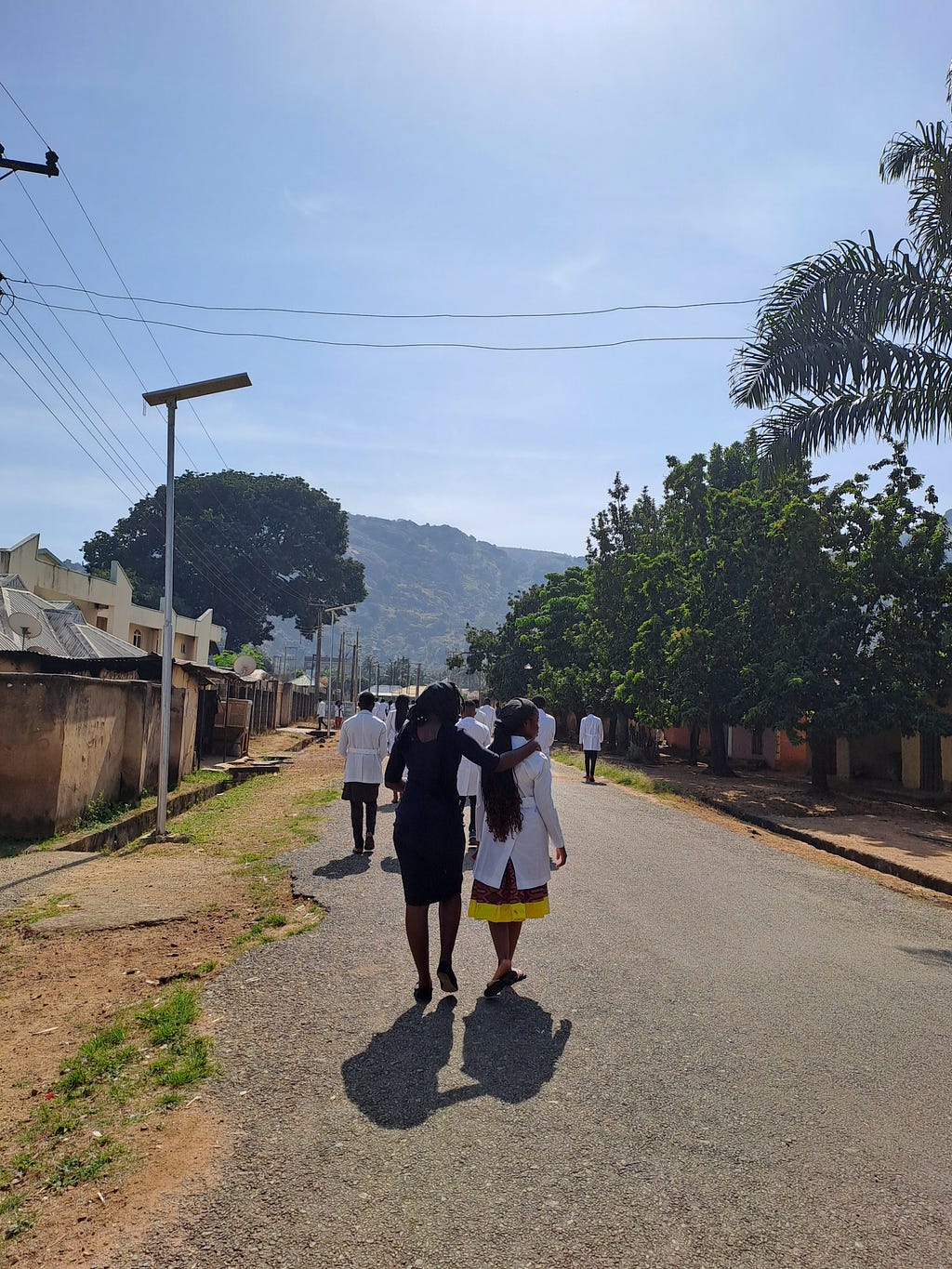 This is a backshot of Nkay and Ebiere on the road leading to church,