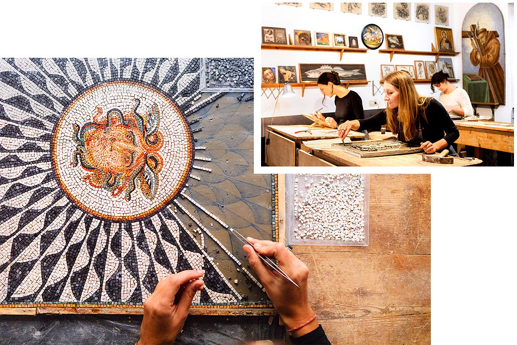 A mosaic being made in a starburst design; two women at tables work on their mosaic tiling.