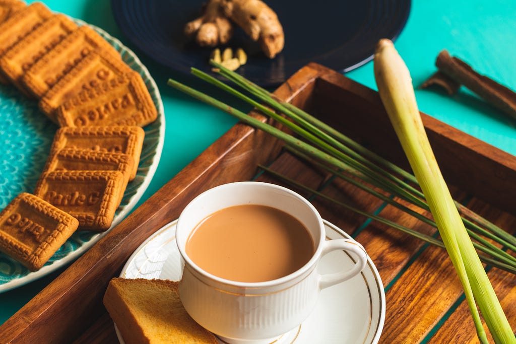 Indian Chai, served with ParleG and some of its ingredients in the background