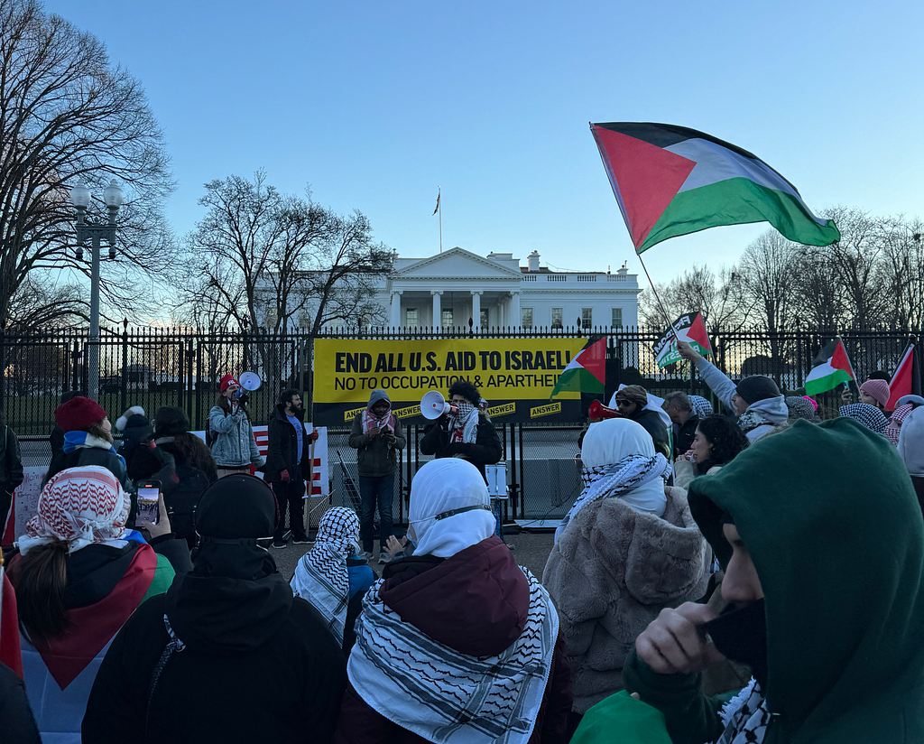 Marchers at the March for Gaza outside of the White House with a sign that reads “End All U.S. Aid to Israel!”