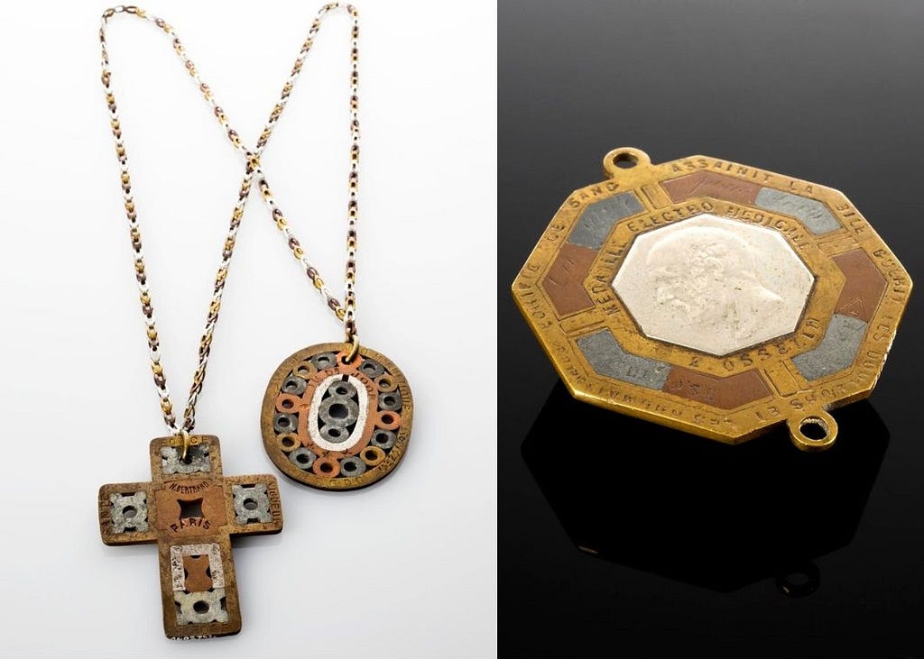 Left hand side image shows two metal necklaces (one cross and one oval shaped). The right hand side image shows a metal broach.