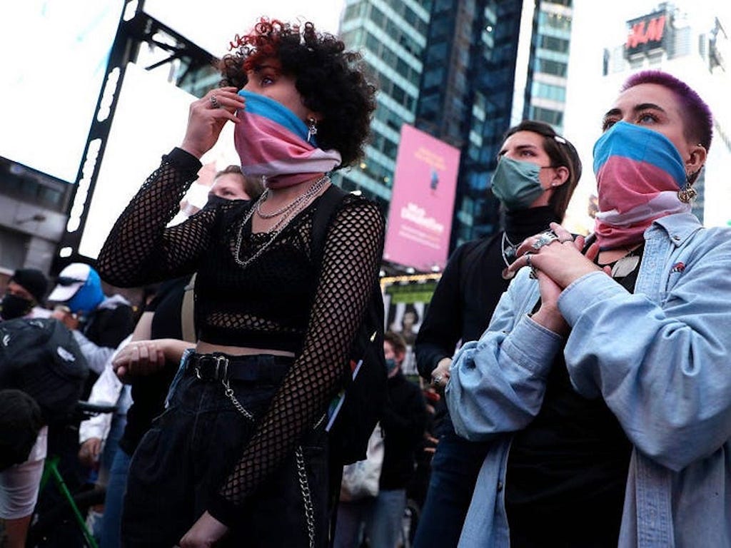 Demonstrators show support for the trans community.