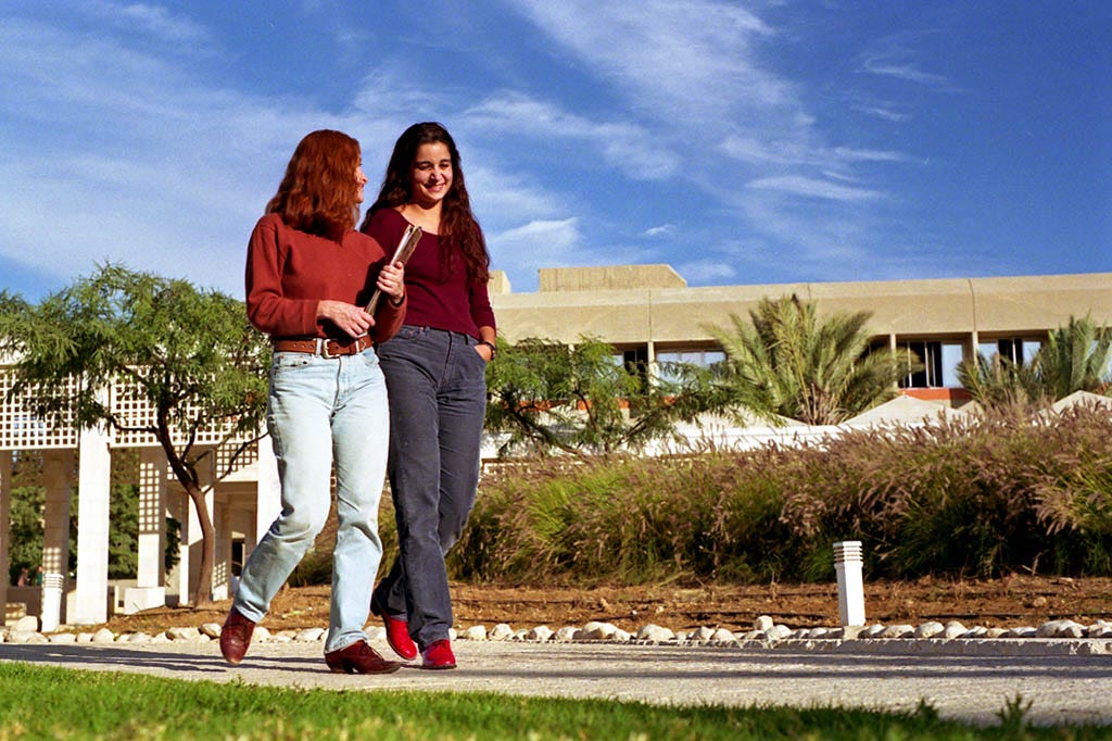 Two female students walking along path at Ben Gurion University of the Negev (Judah S. Harris)