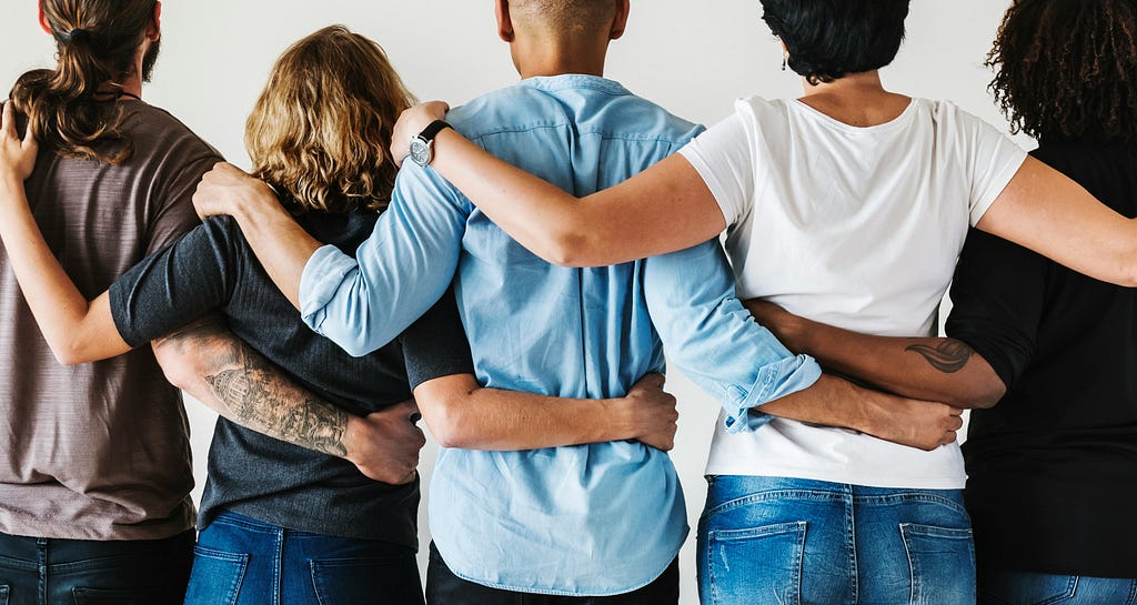 Group of people arm in arm