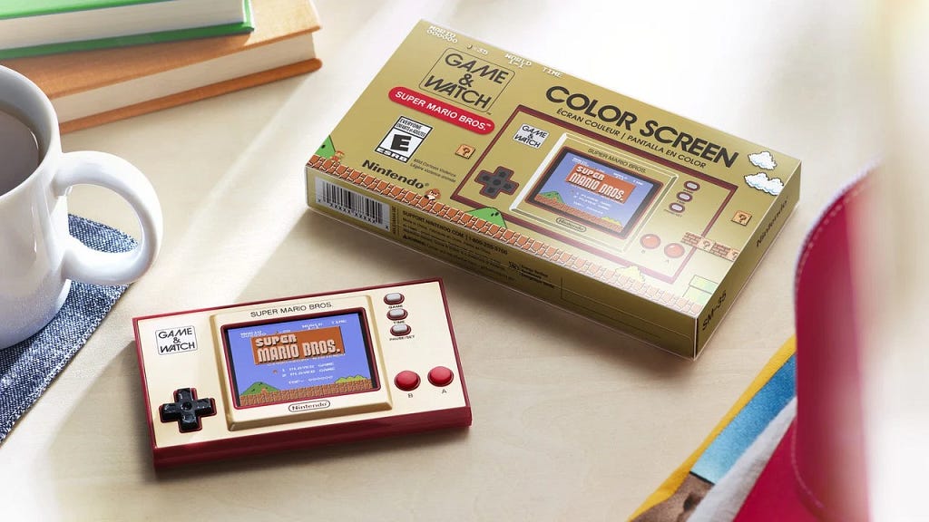 A Super Mario Bros Game and Watch handheld with a retro case referencing the old school boxes of the 80s