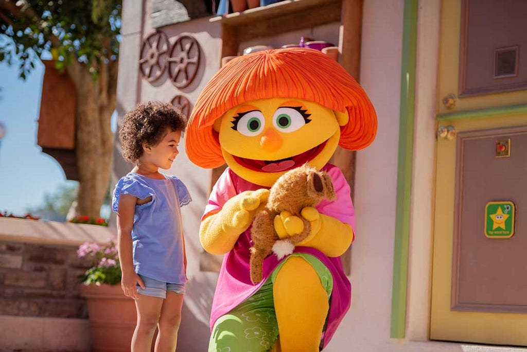 Julia, autistic muppet interacting with a young girl