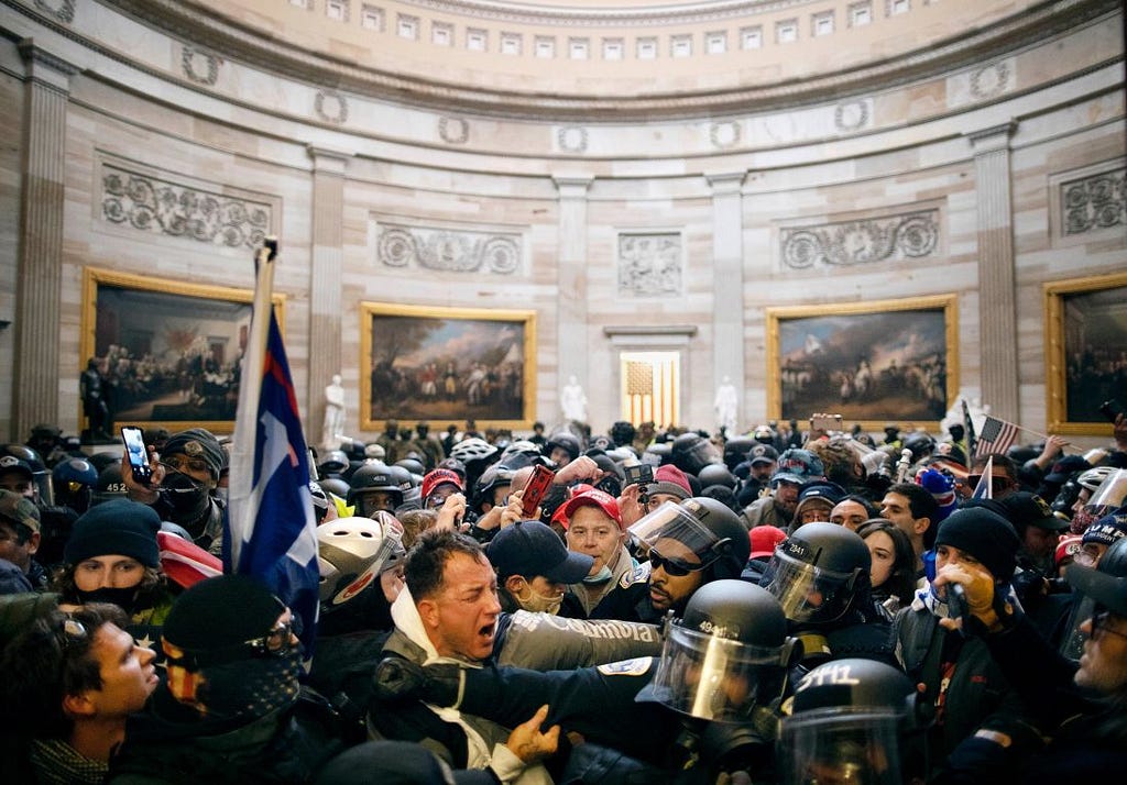 Police clash with pro-Trump rioters who had entered the Capitol.