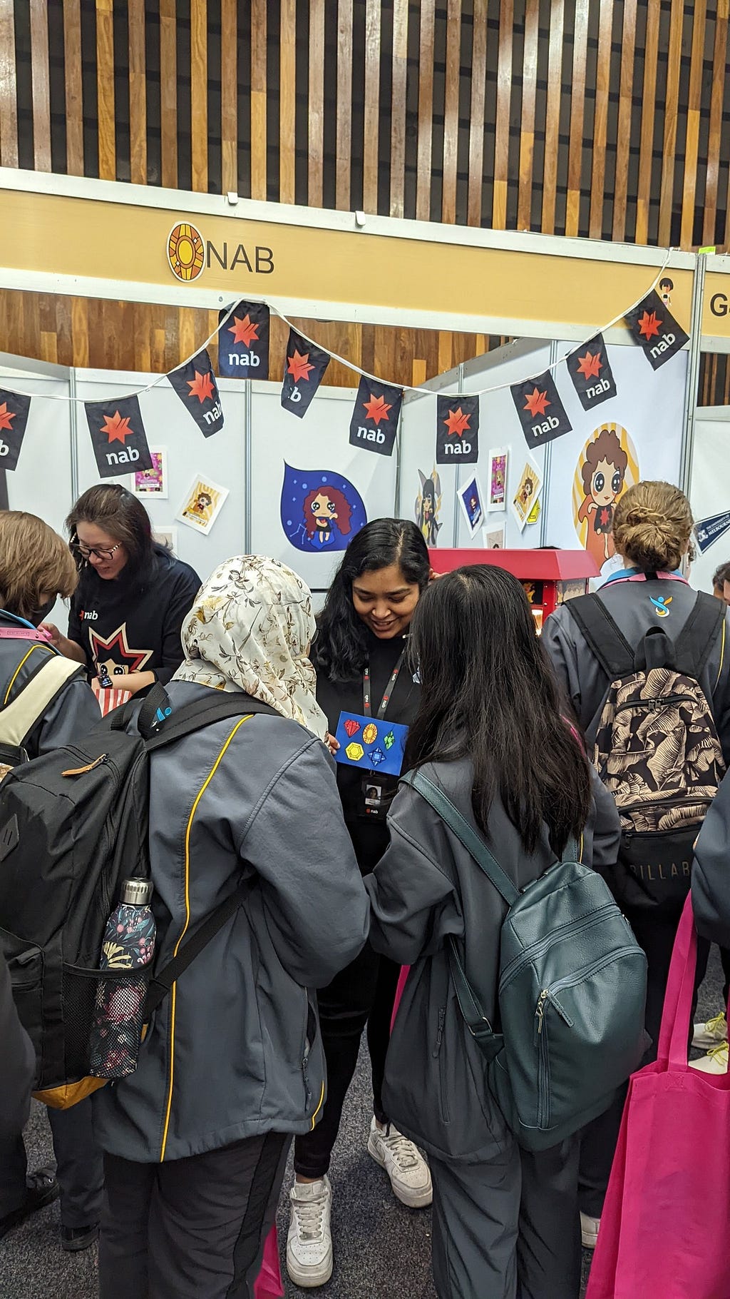 NAB volunteers talking to students in front of the NAB booth