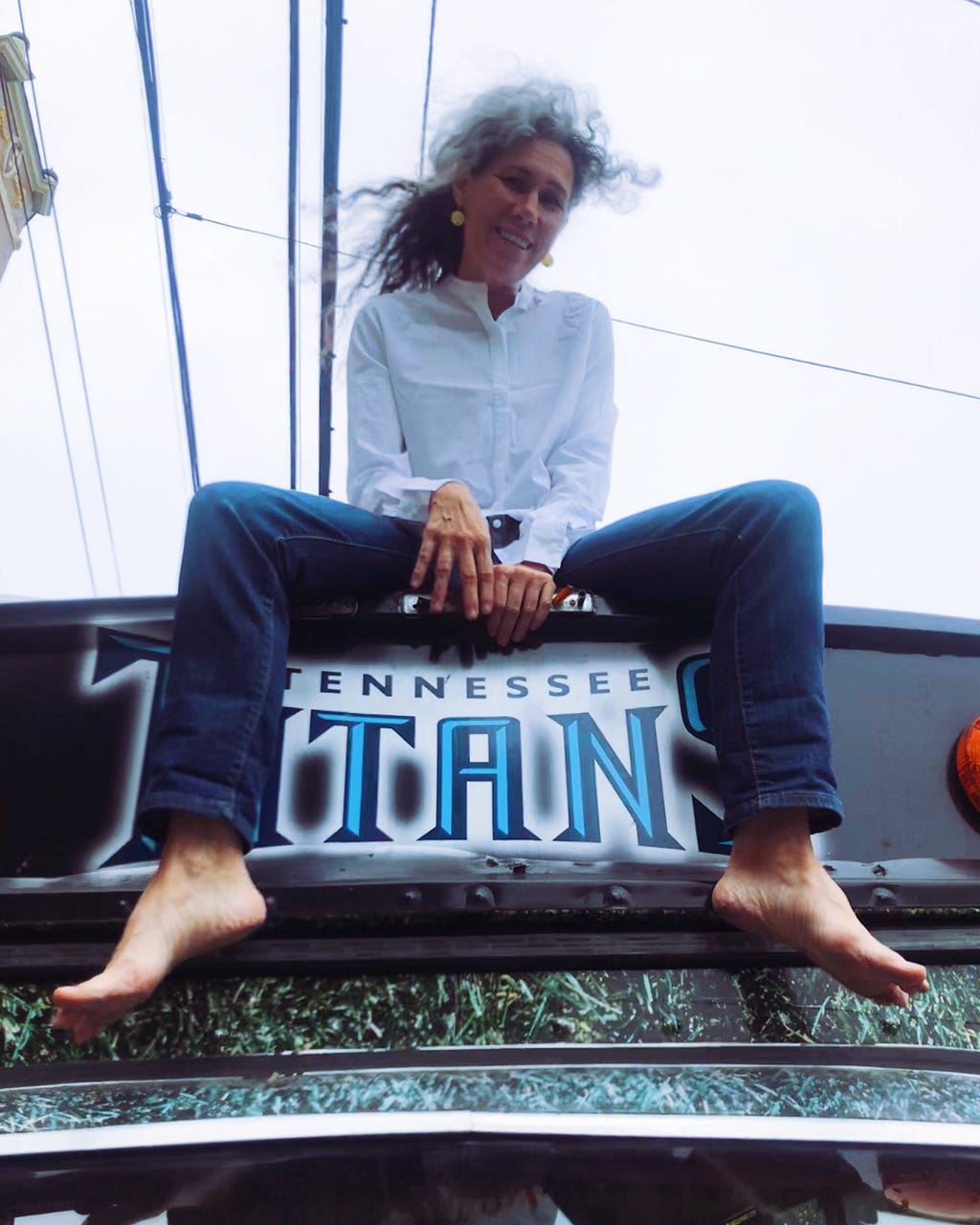 woman sits atop a bus