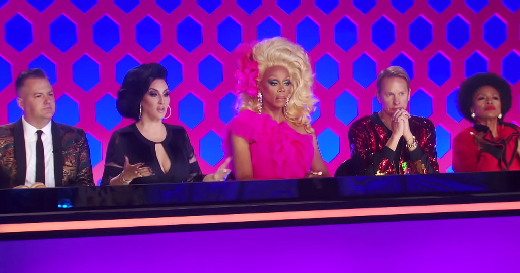 A photo of a judging panel from American TV show: RuPaul’s Drag Race.