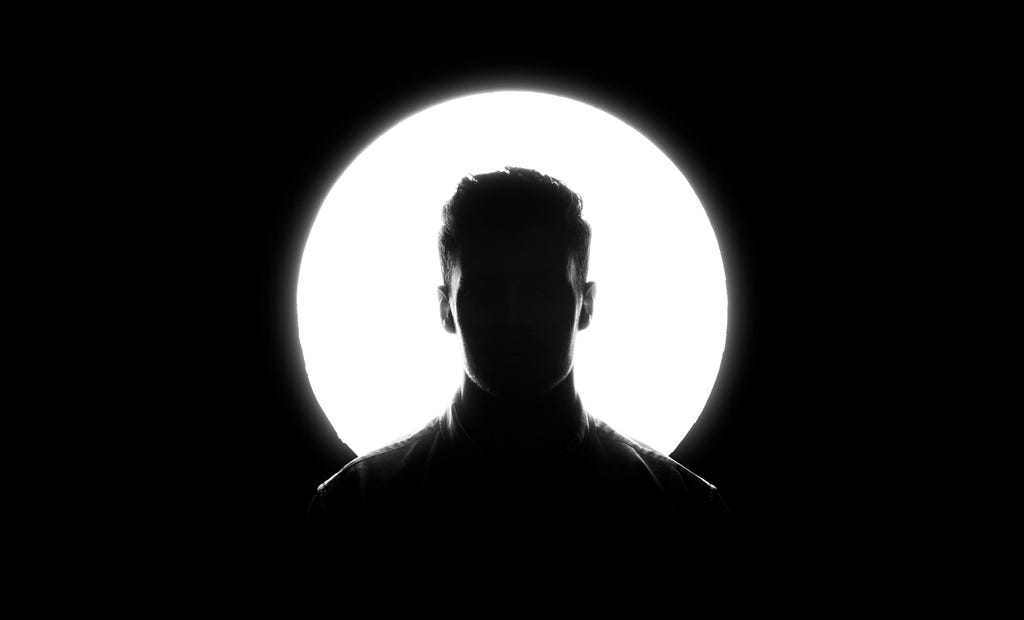 A silhouette of a man with a light behind him, signifying him being visible.