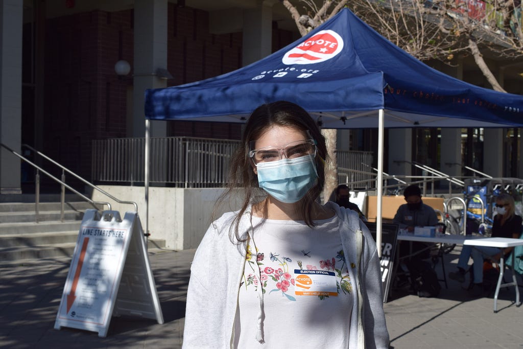 a high school student in front of a polling place at UC Berkeley