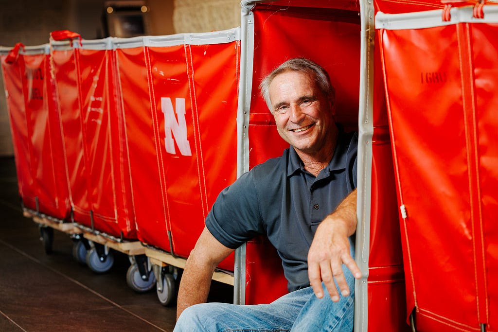 Larry smiles for a photo leaning into the red move-in carts