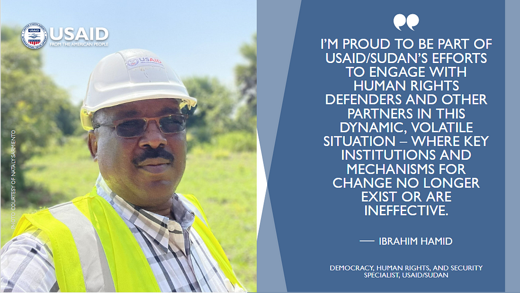 A photograph of a man in a yellow safety vest and hard hat juxtaposed with a graphic that quotes him saying: “I’m proud to be part of USAID/Sudan’s efforts to engage with human rights defenders and other partners in this dynamic, volatile situation — where key institutions and mechanisms for change no longer exist or are ineffective.”