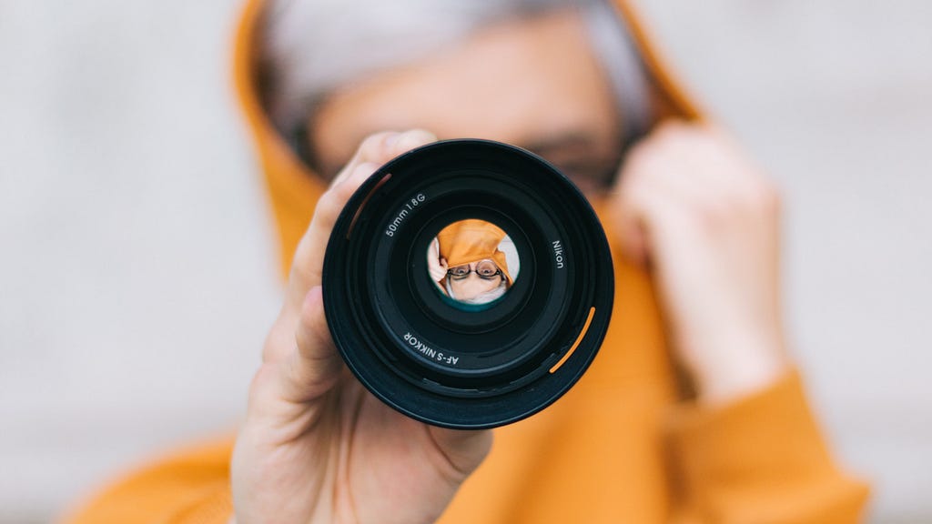 Viewing through a camera lens to see a person close up.