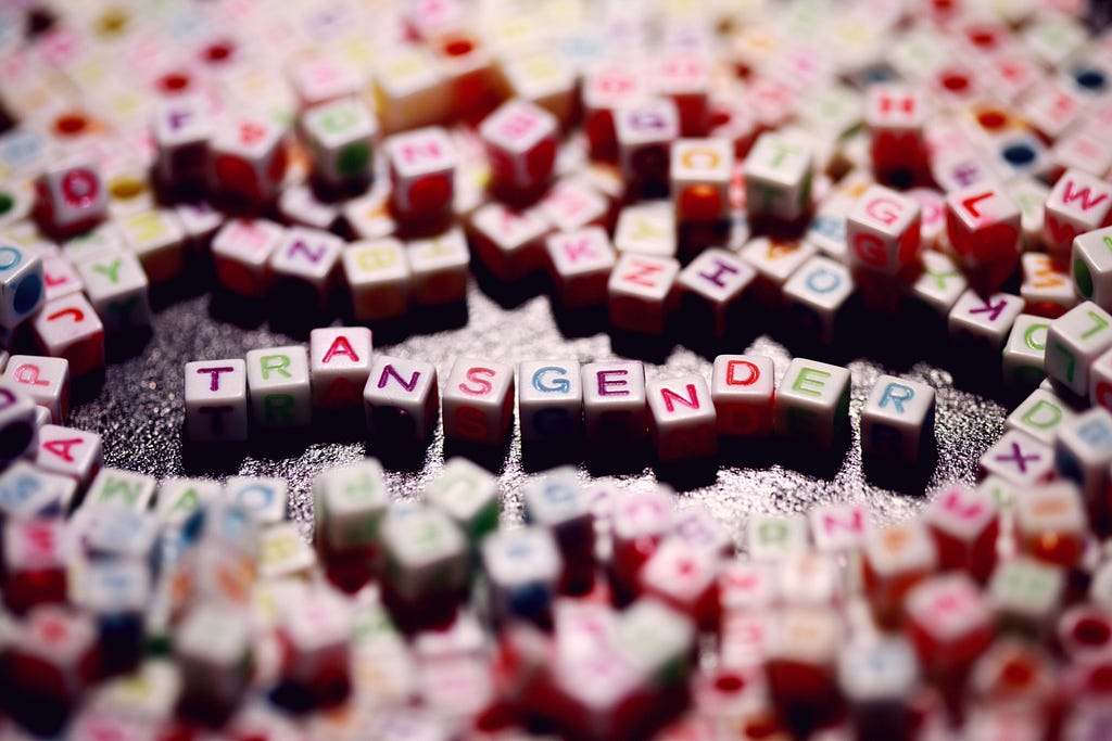 alphabet blocks of many colors spelling the word transgender