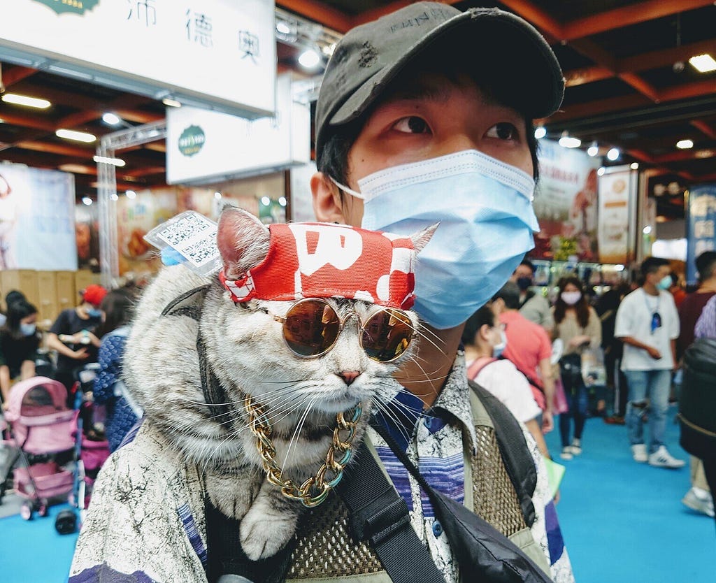 Man with cat on his shoulder at the Taipei Pet Show