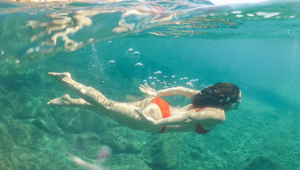 Woman Swimming in Ocean wearing Flow Fairy Menstrual Cup