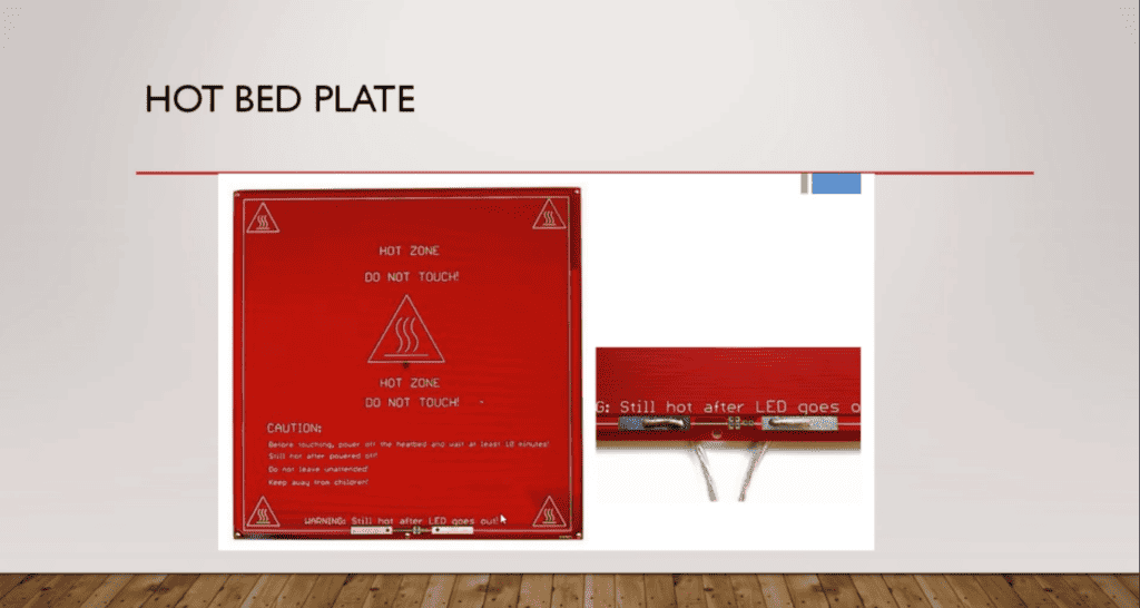 Safety first: A 3D printer’s hot bed plate marked with cautionary instructions to prevent burns.