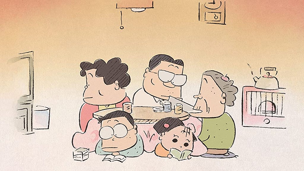 the whole family sitting under a kotatsu