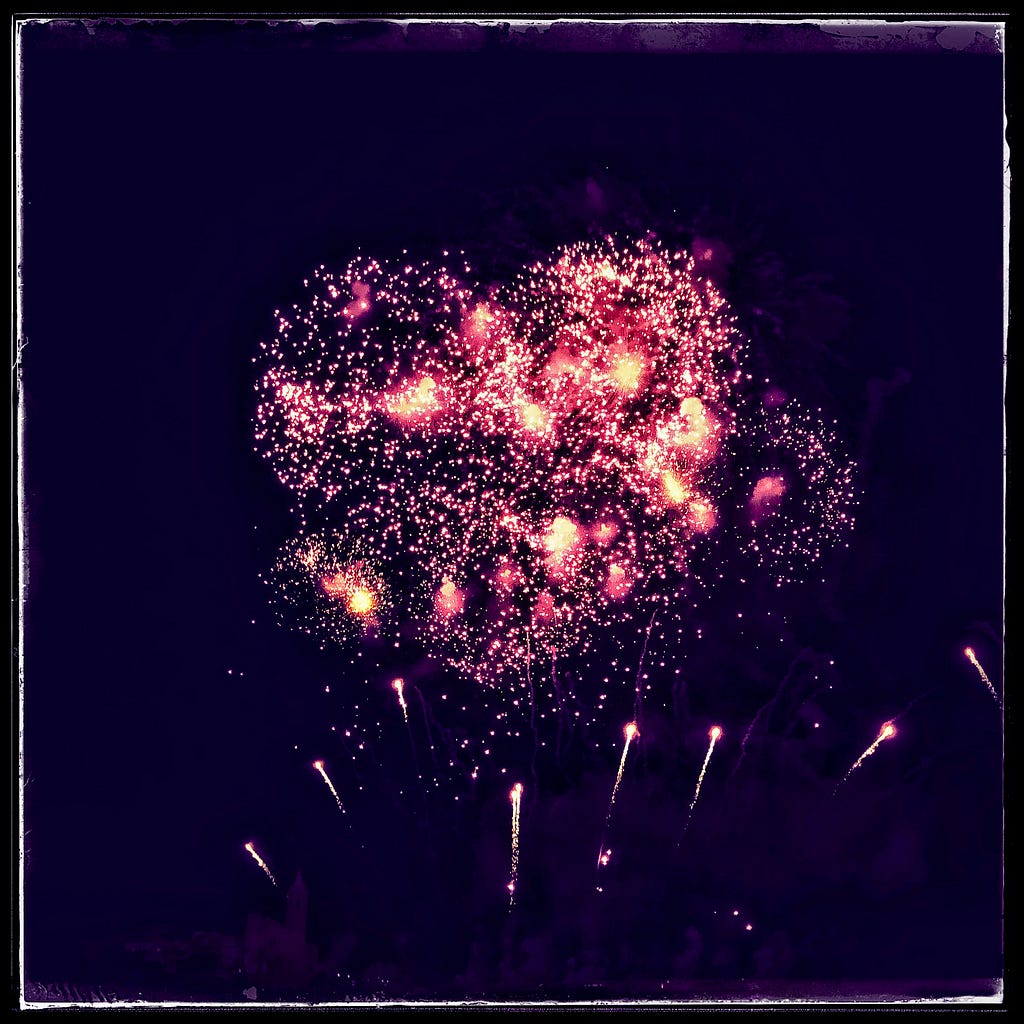 Fireworks exploding in the shape of a heart.