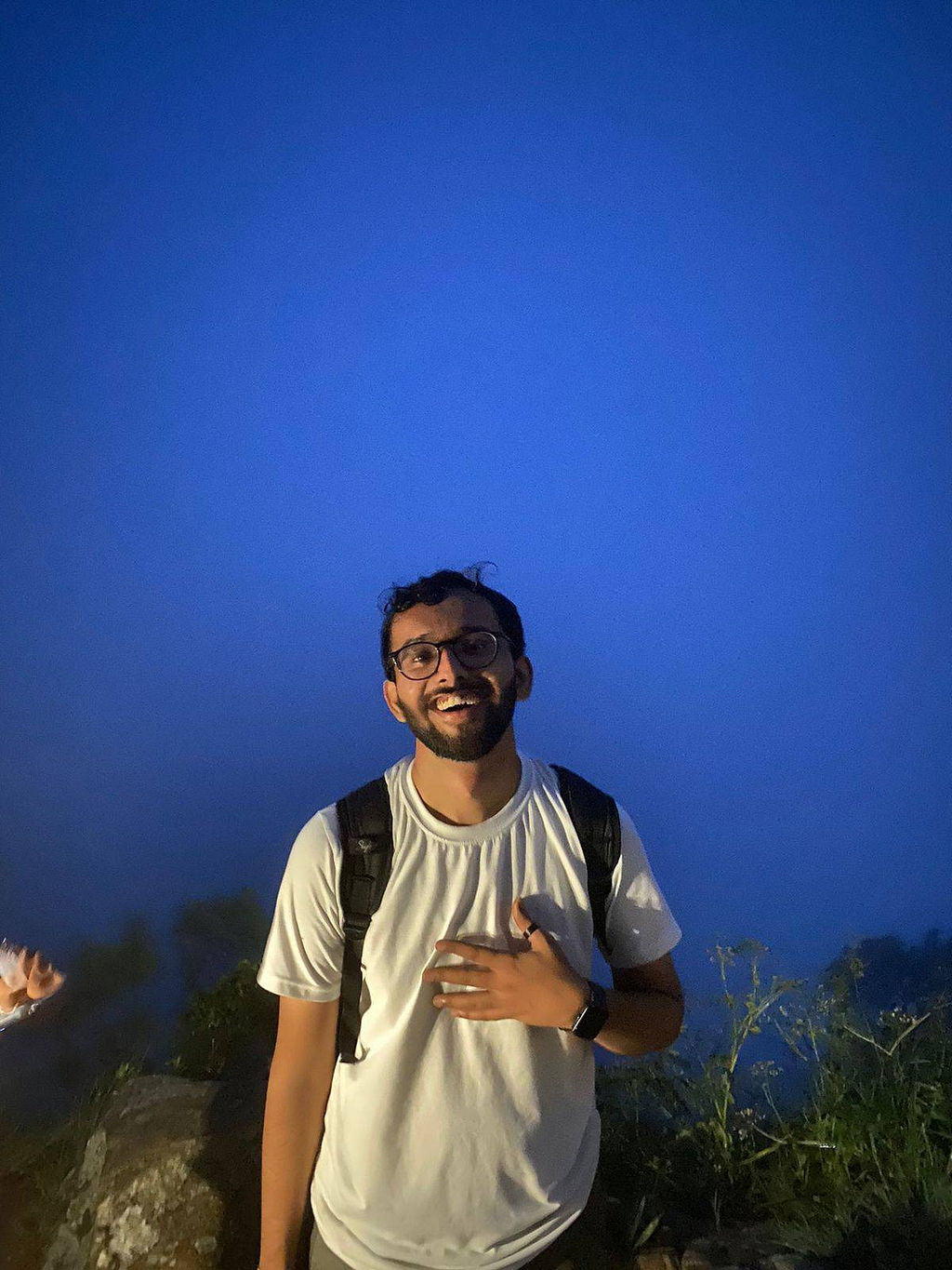 Kartik Joshi against the backdrop of clouds that cover the view of the city.