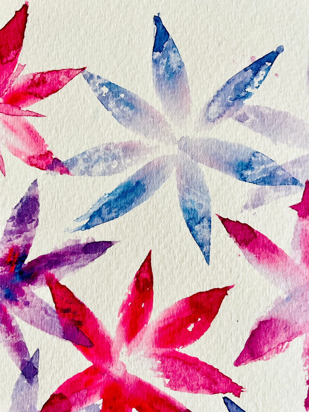 close up of pink, blue and purple watercolor flowers