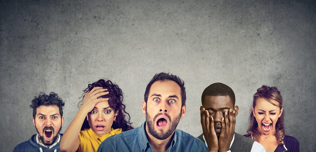 A group of six diverse people with shocked expressions on their faces.