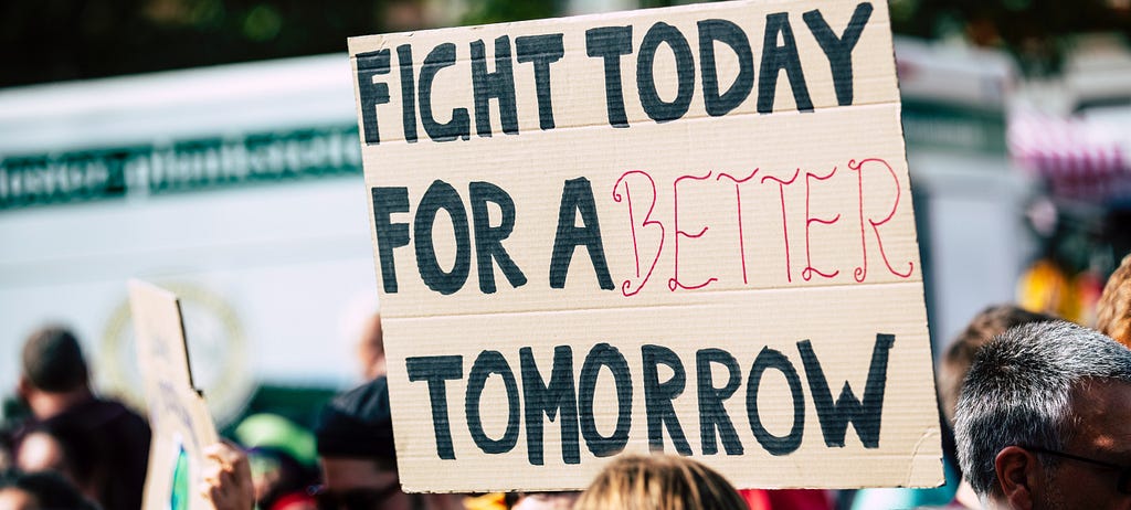 A protest sign on a climate march. The sign says: “Fight today for a better tomorrow”