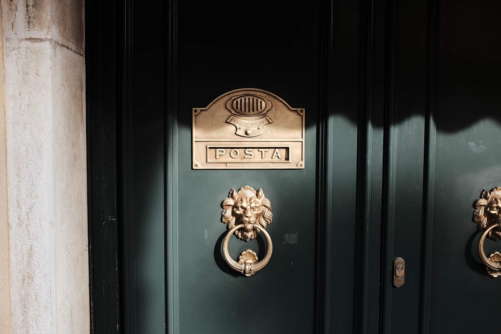 door and mailbox details with golden adornments