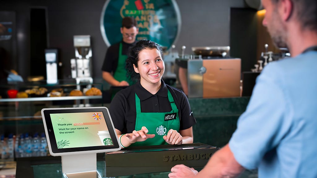 A starbucks employee cashier with a device solution for the problem statement