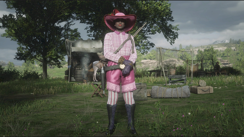 Bess’s character wearing her pink blouse, pants, and hat.