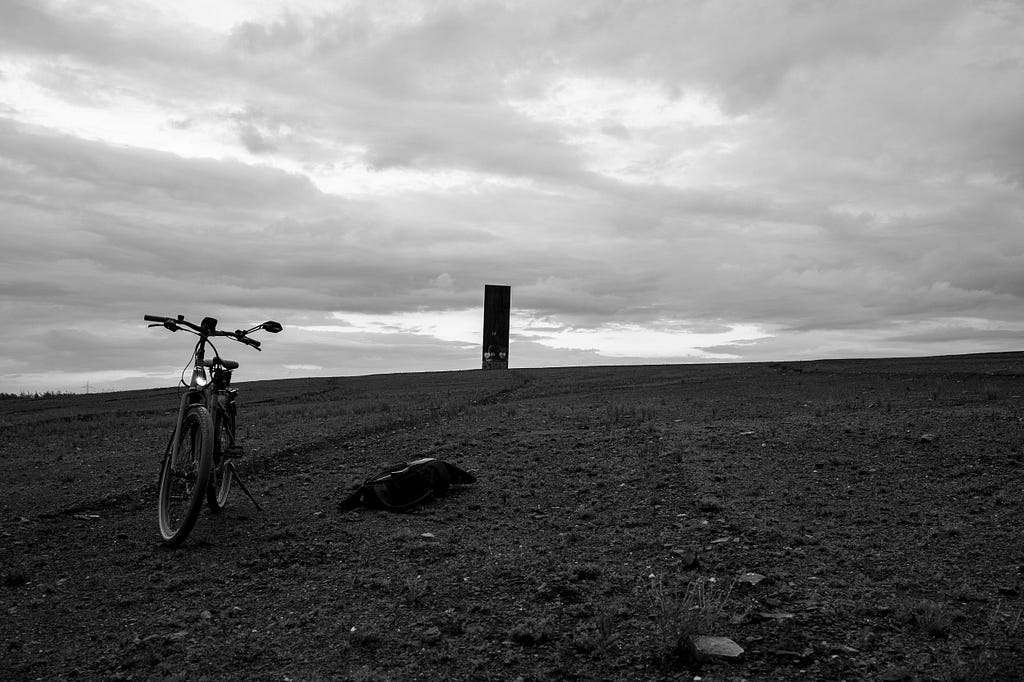 The view from the waste tip Schurenbachhalde near sunset shows the former coal mine Prosper, the still operational coking plant Prosper, and other reminders of the region’s industrial past and present. Here, I experimented with the bicycle as part of the composition. Essen, Germany, September 28, 2022.