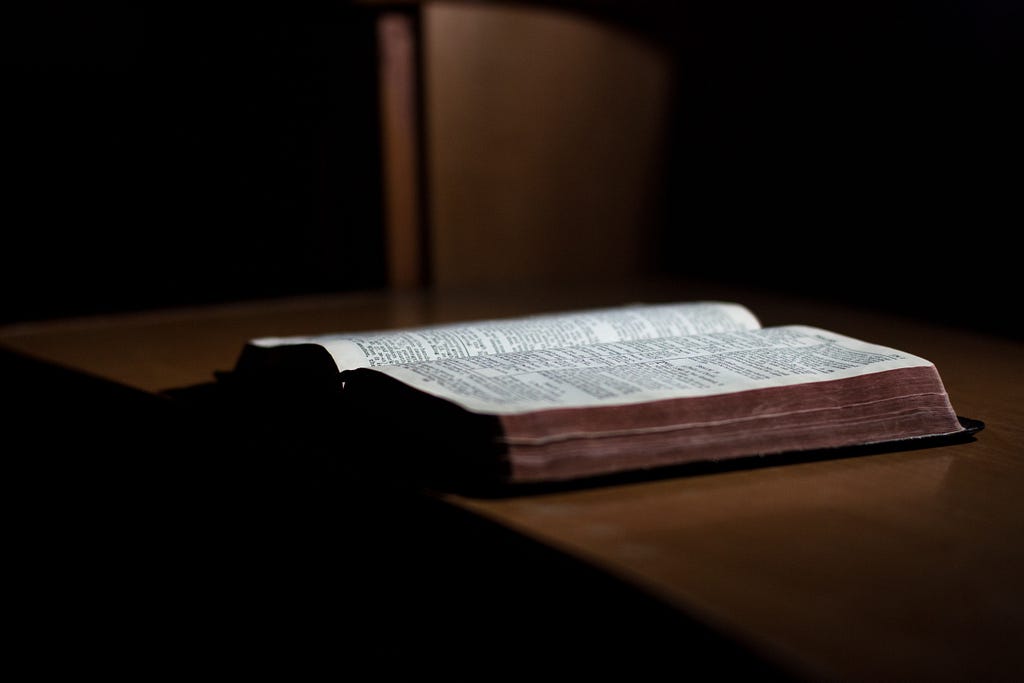 open Bible on a brown table