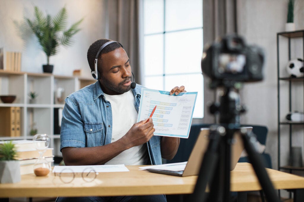 Freelancer/Consultant man presenting a chart on camera for a video recording.