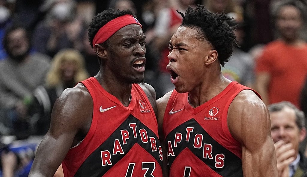 Scottie Barnes and Pascal Siakam share a moment after a big play.