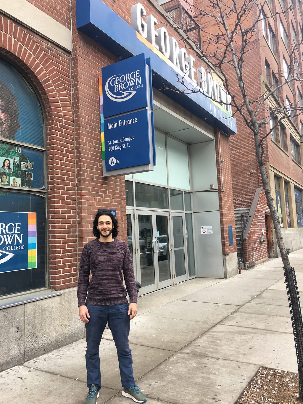 Muhammed Ebrar Aydin standing in front of George Brown College. Muhammed Aydin. LegendofEbrar.