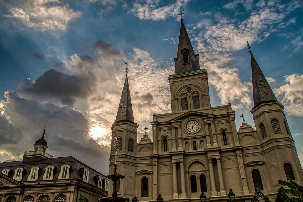 Image of Saint Louis Cathedral by Mick Haupt. Large which church and cloudy blue sky.