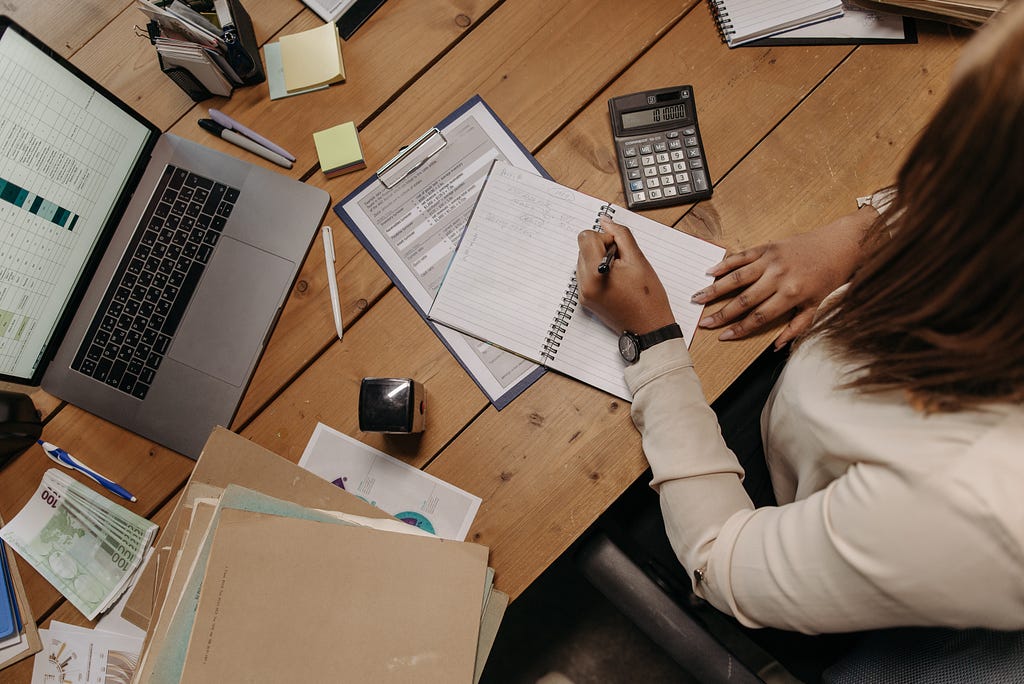 Image of a woman calculating expenses