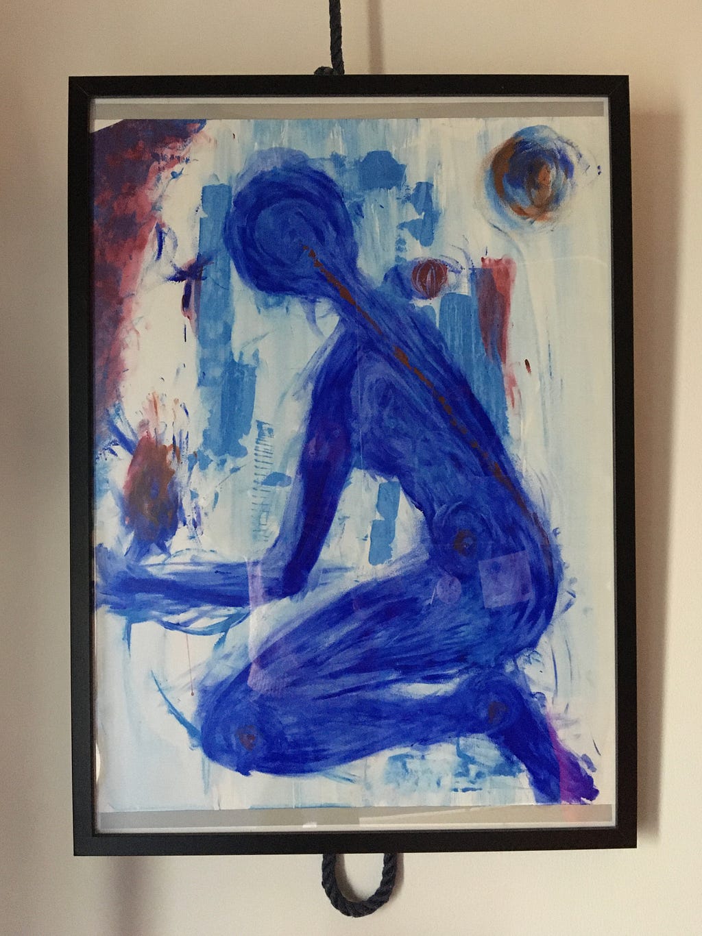painting of blue figure kneeling with abstract burgendy coloured fire in its hand. Red and blue colours behind.